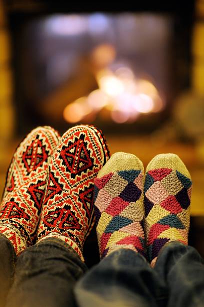 istock Young romantic couple relax on sofa in front of fireplace 494505879