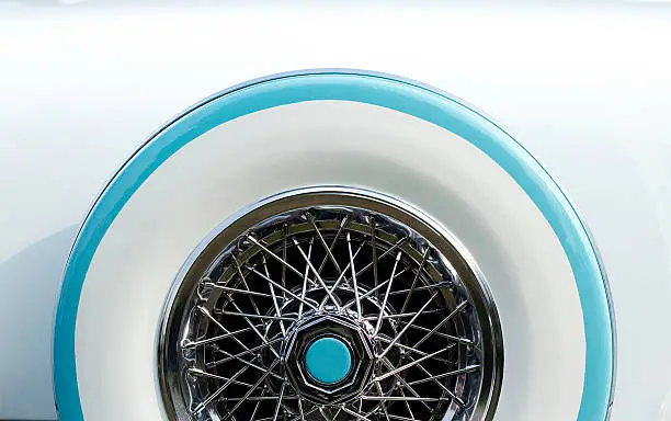 Close Up of a blue and white cadillac wheel.