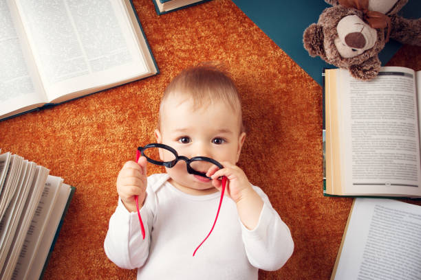 istock One year old baby with spectackles and a teddy bear 494508824