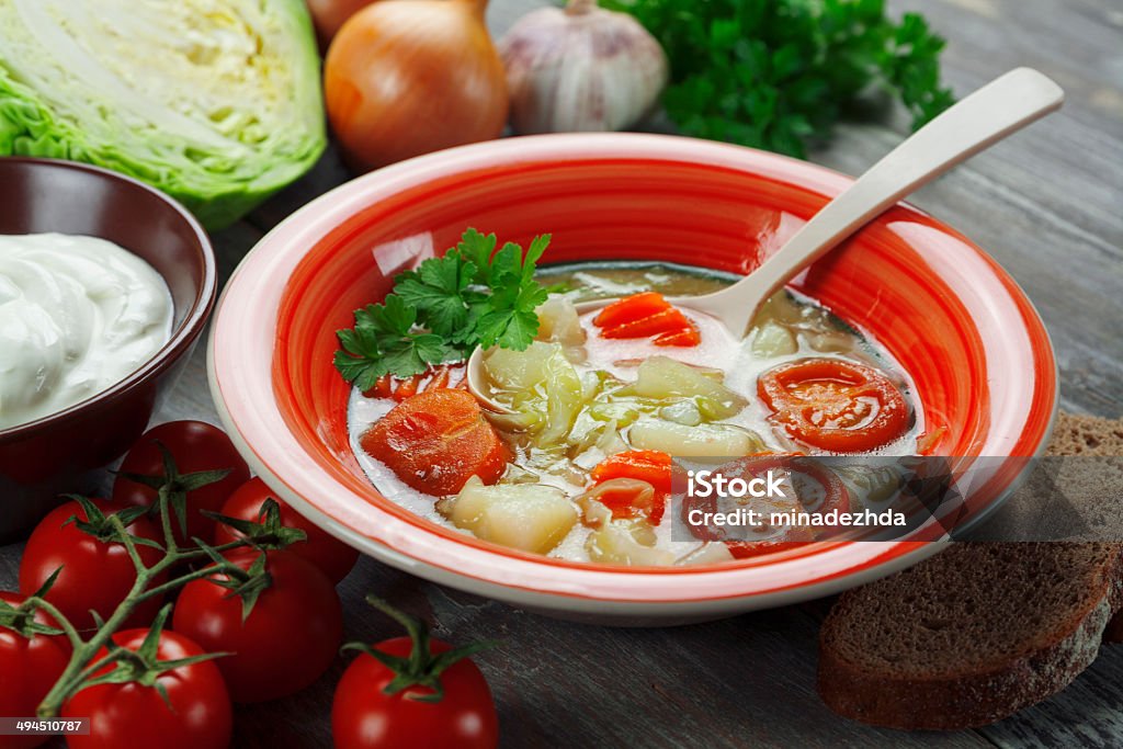 Cabbage soup Cabbage soup and sour cream on the table. Russian traditional dish Borscht Stock Photo
