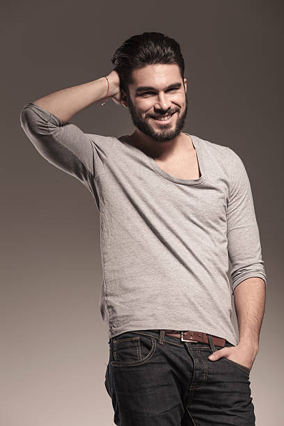 istock smiling young man fixing his hair 494511247