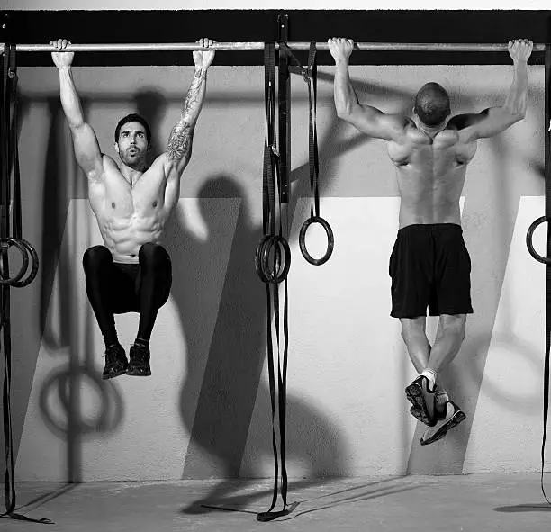 Photo of gym toes to bar men pull-ups 2 bars workout