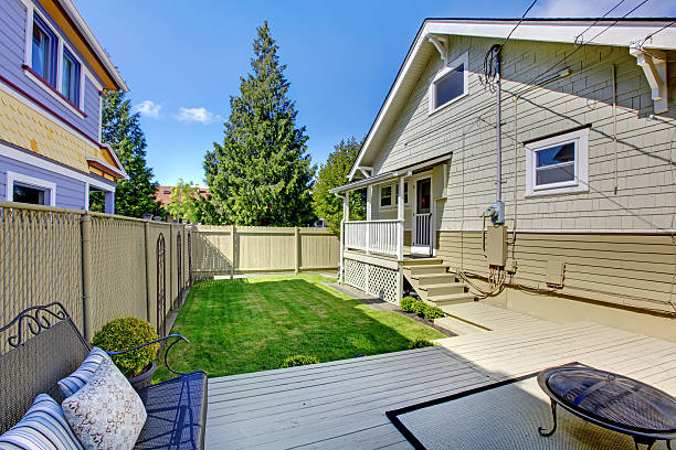 istock Beautiful spring back yard with fence and house. 494522069