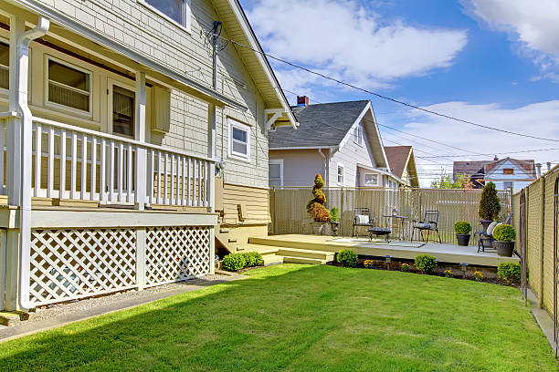 istock Beautiful spring back yard with fence and house. 494522075