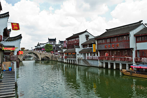Qibao as the only ancient town forming part of greater Shanghai, with a history spanning over one thousand years, Qibao is more than just a living fossil of ancient Chinese conurbation and urban planning. The town was built in Northern Song Dynasty (960-1126) and grew into a prosperous business center during Ming (1368-1644) and Qing Dynasties (1644-1911). Qibao is the Chinese for 'seven treasures' and there are two popular theories about its derivation. The more reliable one says that the name originates from the Qibao Temple, famed for its good reputation. It was this that contributed to the growth of business and culture of the previously unknown town. The other theory seems more popular among the local people who tell folk tales about seven treasures. These were an iron Buddha made in Ming Dynasty, a bronze bell also dating from the Ming Dynasty but said to have mysteriously appeared from nowhere, a Gold Script Lotus Sutra written by an imperial concubine of the 10th century, a one-thousand-year-old Chinese catalpa tree, a jade axe, a gold cockerel and a pair of jade chopsticks. Actually of these seven treasures, the existence of only first four can be verified while only the Scripture and the bell have survived to this day.