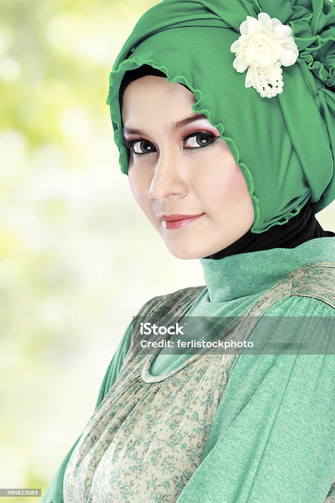 Young happy beautiful muslim woman with green costume wearing hi Fashion portrait of young happy beautiful muslim woman with green costume wearing hijab Adult Stock Photo