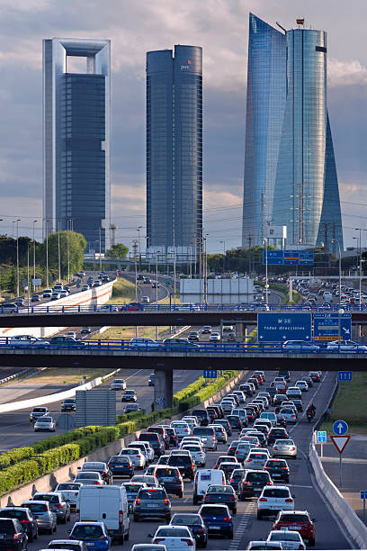 Traffic jam Madrid, Spain - April 29, 2014: Traffic jam at sunset,  in one of the main roads of Madrid. You can see on the back ground  four towers  symbol  of madrid modern contemporary madrid european culture travel destinations stock pictures, royalty-free photos & images