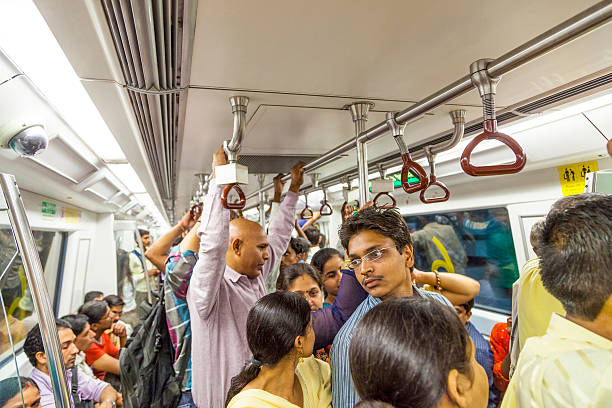 passengers alighting the metro train Delhi, India - October 15, 2012: Jpassengers alighting metro train yellow line at Jahangir Puri station in Delhi, India. Nearly 1 million passengers use the metro daily. delhi metro stock pictures, royalty-free photos & images