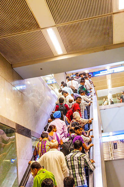 passengers alighting the metro train Delhi, India - October 15, 2012: passengers leave the metro station at Jahangir Puri station in Delhi, India. Nearly 1 million passengers use the metro daily. delhi metro stock pictures, royalty-free photos & images