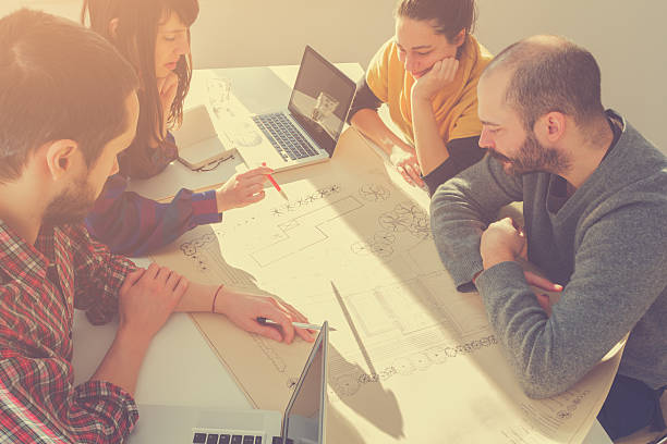 istock Young group of people/architects discussing business plans 494531948