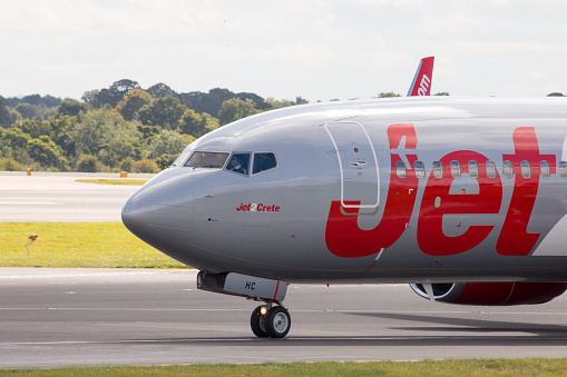 Manchester, United Kingdom - August 27, 2015: Jet2 Boeing 737 passenger plane (G-JZHC) taxiing on taxiway after landing to Manchester International Airport.