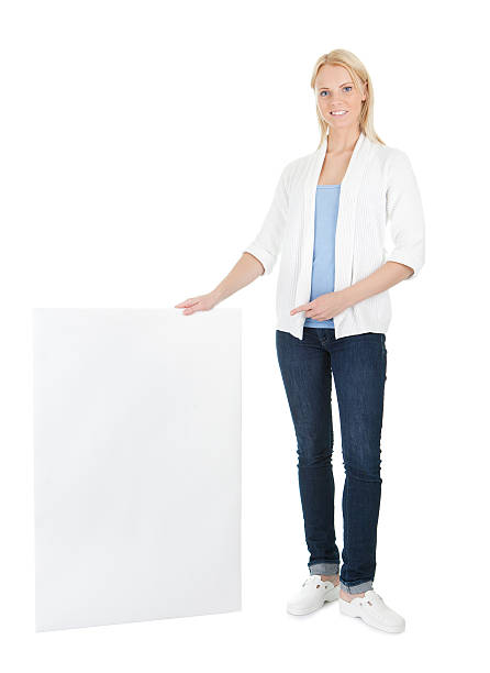istock Beautiful young woman presenting empty board 494532266
