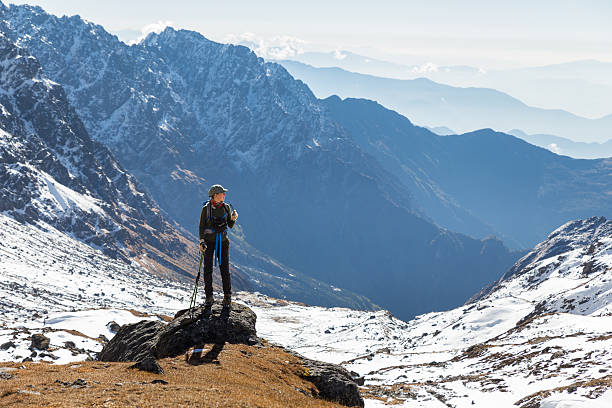 istock Young woman tourist backpacker standing rock mountain edge. 494534858