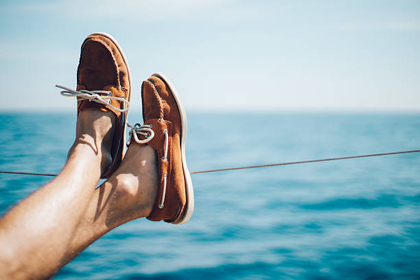 Photo of man legs on the yacht and wearing boat stock photo