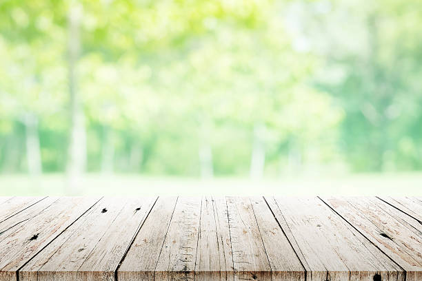 istock Empty wooden table with blurred city park on background 494536842