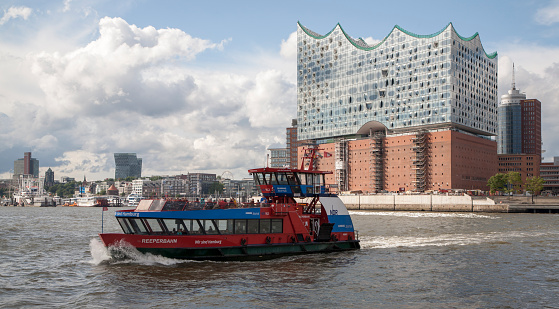 Hamburg,Germany - August 29,2015 : Ferry boat on river  elbe and Hamburgs concert hall Elbphilharmonie 