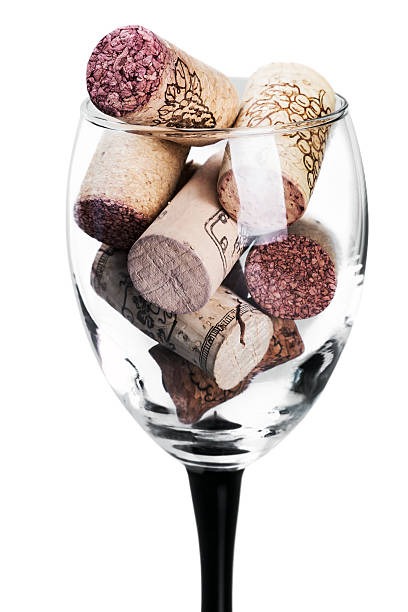 Wine corks in glass isolated Wine corks in glass isolated on white background. Focus on wine corks cork puller stock pictures, royalty-free photos & images