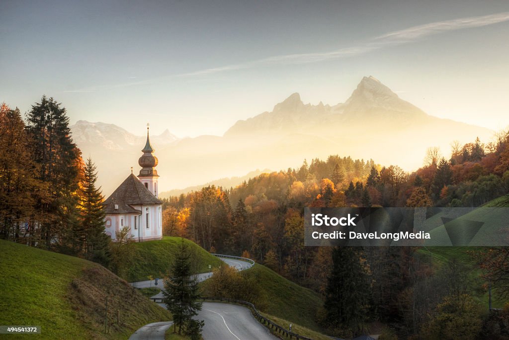 Bavarian Alps with Sunset Shining on Remote Church The church of Maria Gern nestled into a hillside in the Bavarian Alps and located just outside of Berchtesgaden. Germany Stock Photo