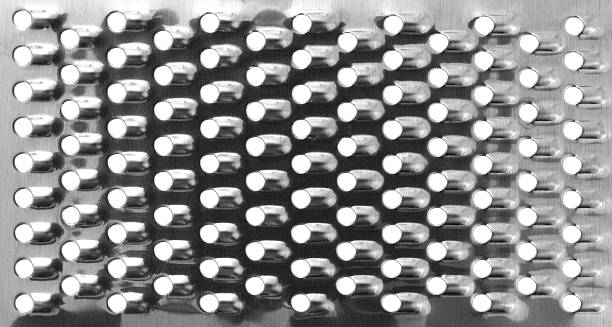 A very close view of a new cheese grater showing the round blades.