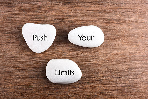 istock White stones with Push your limits word on wooden background 494543130