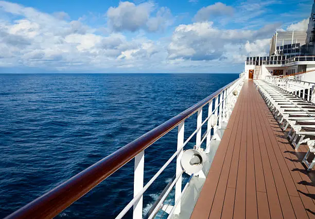 Walking along the deck of a cruise ship at sea