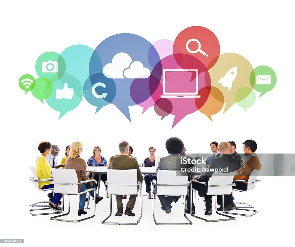 Multiethnic People in a Meeting with Social Media Symbols Multiethnic People in a Meeting with Social Media Symbols. Inspiration Stock Photo