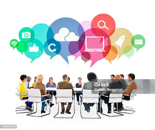 Multiethnic People In A Meeting With Social Media Symbols Stock Photo - Download Image Now