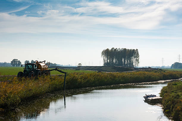 Tractor pumping water from a river
