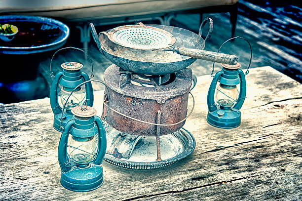 istock Kerosene lamp and vintage pan on the wooden table 494546183