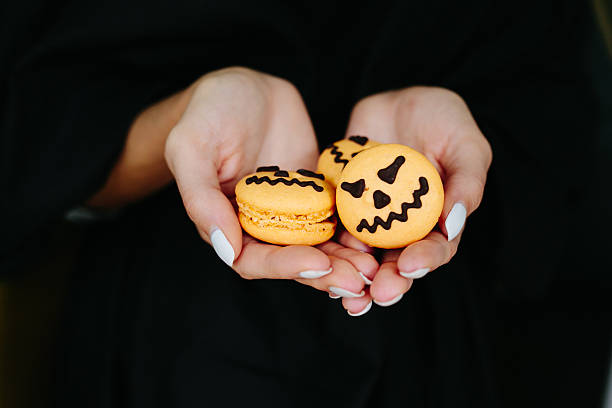istock woman holding a biscuit for Halloween 494547694