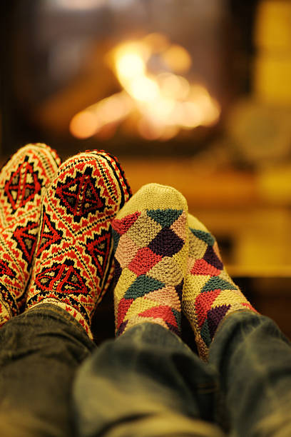 istock Young romantic couple sitting and relaxing in front of fireplace 494557005