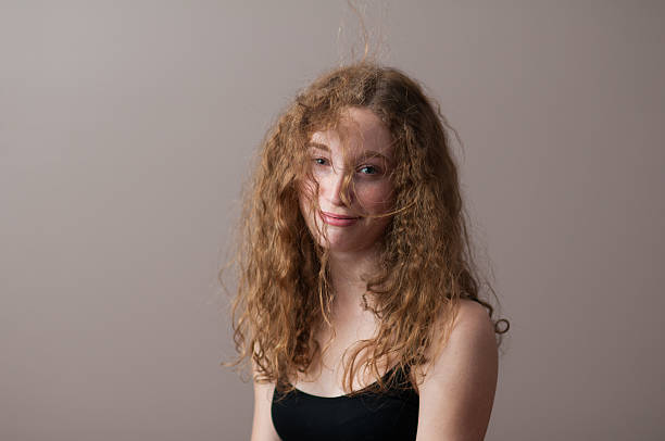 messy hair teenage girl looking exasperated with messy hair frizzy stock pictures, royalty-free photos & images