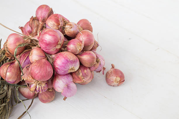 istock red onions on  wooden background 494559044