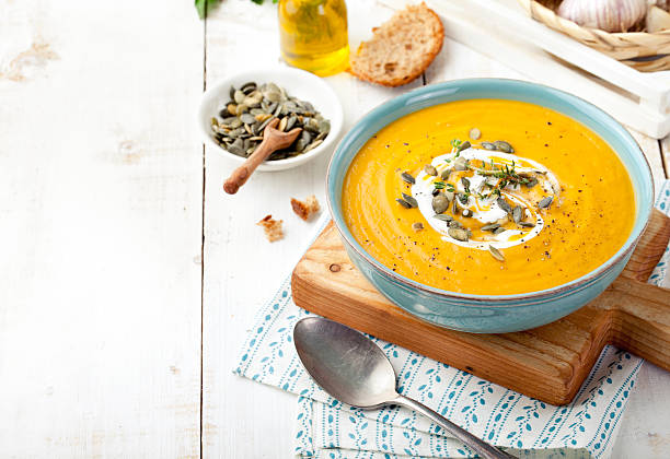 Roasted pumpkin and carrot soup with cream .