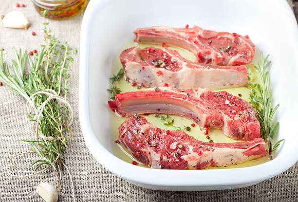 Raw meat, mutton, lamb rack with marinated stock photo