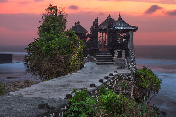 Pura Tanah Lot temple by the sea Right after sunset all people disappeared here for just a couple of minutes - my chance! tanah lot temple bali indonesia stock pictures, royalty-free photos & images