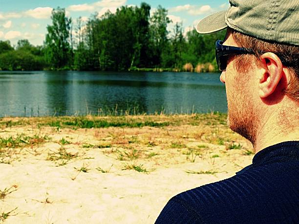 istock Boy with glasses and  cap, dressed in sportswear on beach 494561014