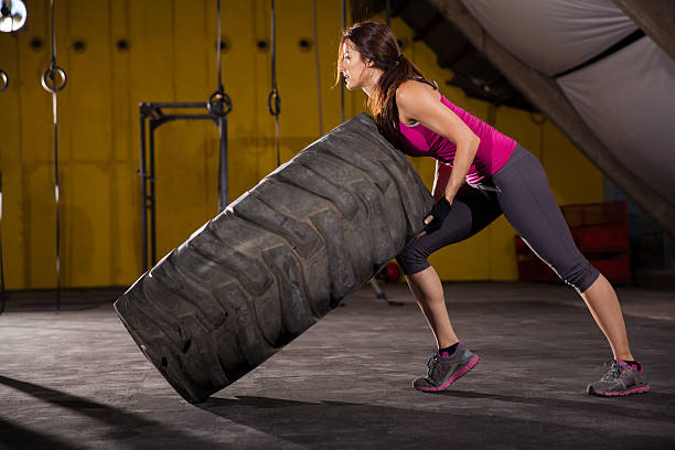 istock Cute girl flipping a tire 494561083