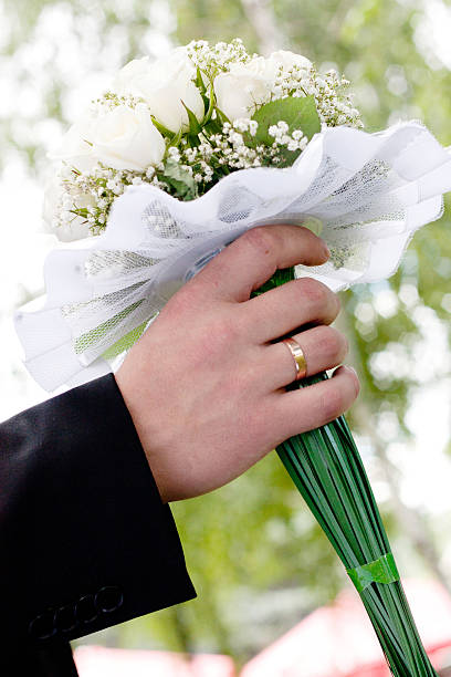 istock wedding bouquet at groom's hands 494561253