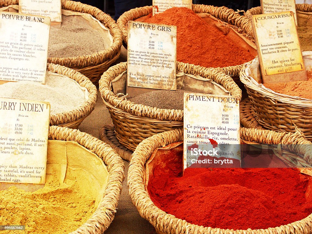 Spice stall with oriental spices in the French Provence Baskets with ground white, black ans chili pepper,Indian curry and couscarissa spices on display at the market in a village of the Provence in France. 2015 Stock Photo