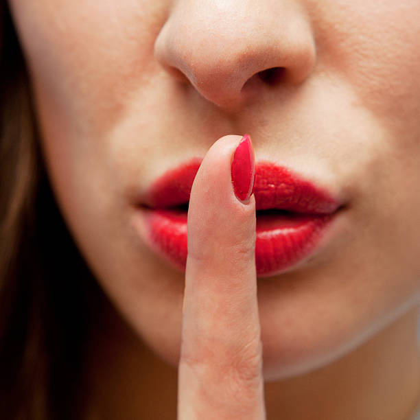 istock Young sexy woman with finger on her lips 494561798