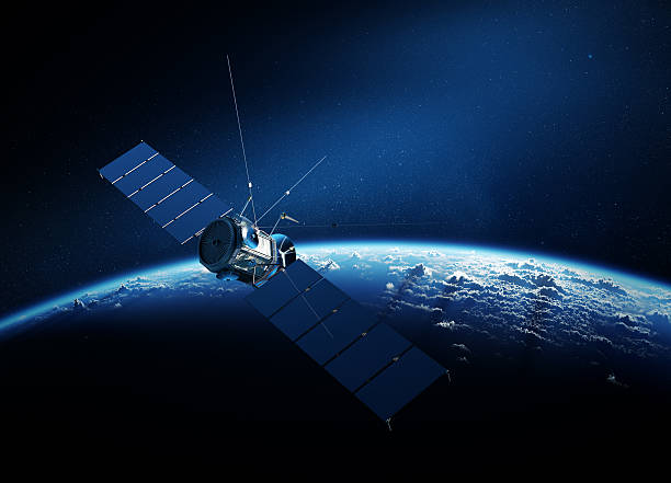 Communications satellite orbiting earth Communications satellite orbiting Earth with sunrise in space satellite stock pictures, royalty-free photos & images
