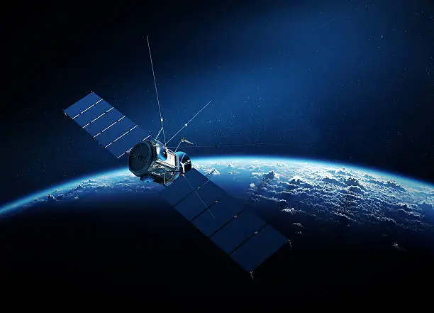 Photo of Communications satellite orbiting earth