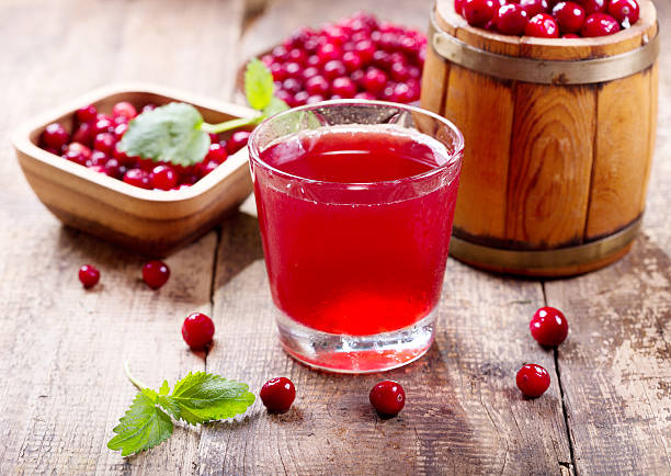 glass of cranberry juice with fresh berries stock photo