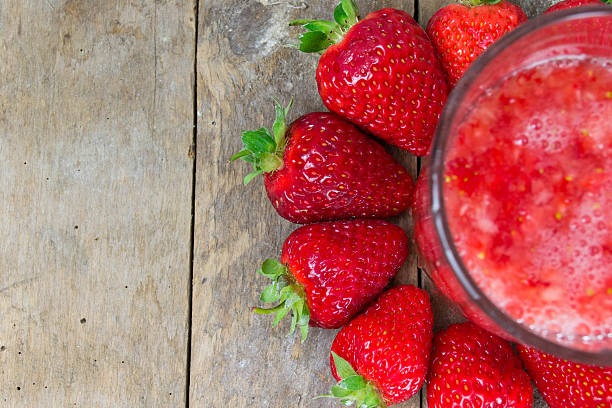 istock Fresh strawberry drink on wood background 494563827