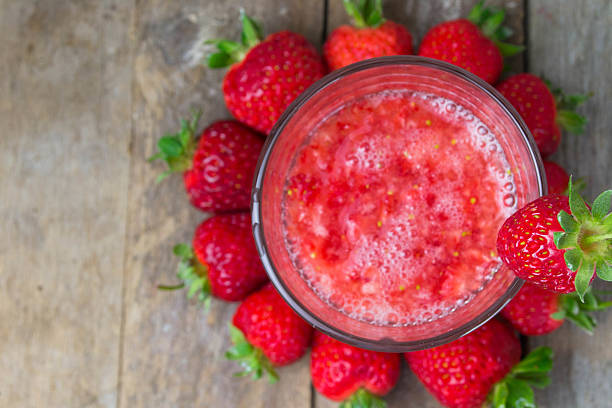 istock Fresh strawberry drink on wood background 494563899