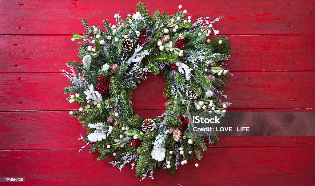 Christmas Wreath Christmas Wreath hung on red barn board background. Copy space. Christmas Stock Photo