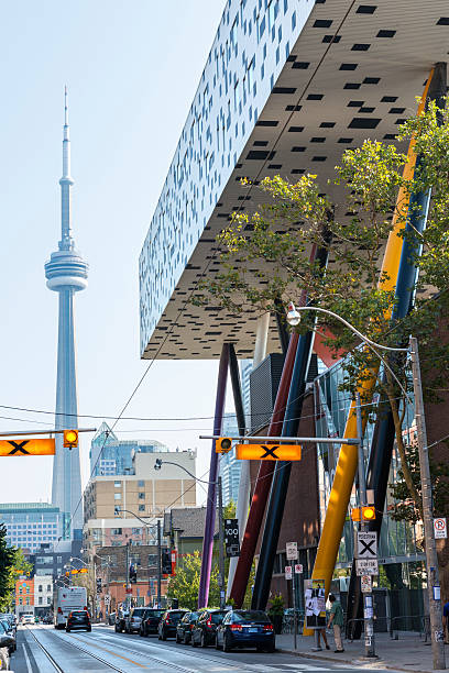 Sharp Centre for Design, Ontario College of Art Toronto, Сanada - September 5, 2015: Low-angle view of the modern expansion of the Sharp Centre for Design at the campus of the Ontario College of Art (OCAD) in downtown Toronto, with the CN tower in the background. The building consists of an elevated white and black box supported by a series of multicolored inclined pillars. ocad stock pictures, royalty-free photos & images
