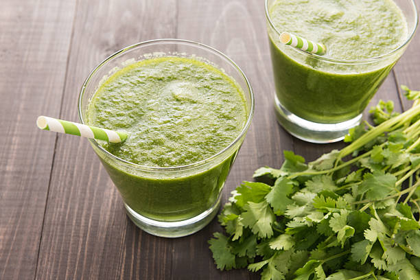 istock Healthy green vegetables and green fruit smoothie on rustic wood 494566286