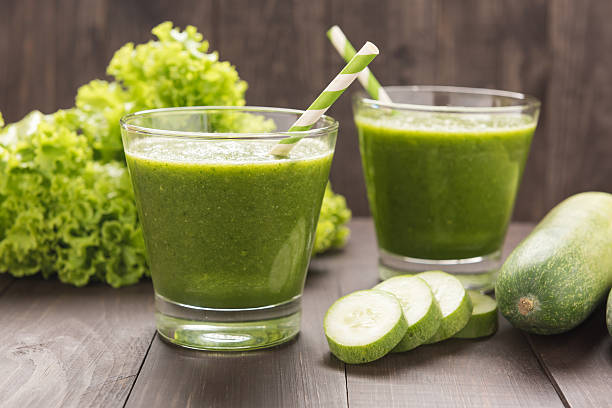 istock Healthy green vegetables and green fruit smoothie on rustic wood 494567352